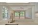 Open-concept view from kitchen to living room featuring a waterfront view through large windows at 3317 Highlands Bridge Rd # 61, Sarasota, FL 34235