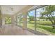 Enclosed patio with large windows offers scenic views of the lush landscaping and pond at 3317 Highlands Bridge Rd # 61, Sarasota, FL 34235