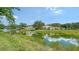 Scenic view of a pond with fountain and lush landscaping, reflecting the nearby homes at 3317 Highlands Bridge Rd # 61, Sarasota, FL 34235