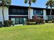 Beautiful backyard features a manicured lawn, mature palms, and an inviting patio area for outdoor enjoyment at 3500 El Conquistador Pkwy # 347, Bradenton, FL 34210