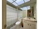 Bathroom featuring a toilet, vanity, mirror, and shower with gray and white striped curtain at 3500 El Conquistador Pkwy # 347, Bradenton, FL 34210
