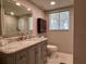 Bathroom featuring a granite vanity, modern toilet, and large mirror for a luxurious feel at 3500 El Conquistador Pkwy # 347, Bradenton, FL 34210