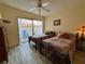 Bedroom with two beds, ceiling fan, a sliding glass door at 3500 El Conquistador Pkwy # 347, Bradenton, FL 34210