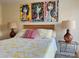 Bright bedroom featuring colorful artwork above the bed and two lamps at 3500 El Conquistador Pkwy # 347, Bradenton, FL 34210