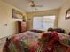 Bedroom featuring two twin beds with ceiling fan and sliding glass door at 3500 El Conquistador Pkwy # 347, Bradenton, FL 34210