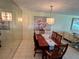 Charming dining room with stylish chandelier, ample seating, and a large decorative painting at 3500 El Conquistador Pkwy # 347, Bradenton, FL 34210