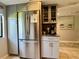 Updated kitchen features a stainless refrigerator, updated cabinets, and an adjacent eating area with a coffee bar at 3500 El Conquistador Pkwy # 347, Bradenton, FL 34210