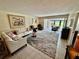 Bright living area with a comfortable sectional, accent chairs, and views of the outdoor patio at 3500 El Conquistador Pkwy # 347, Bradenton, FL 34210