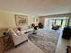 Comfortable living room with sectional seating, stylish décor, and views of the backyard at 3500 El Conquistador Pkwy # 347, Bradenton, FL 34210