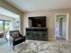 Cozy living room with entertainment center and views to a bright enclosed lanai at 3500 El Conquistador Pkwy # 347, Bradenton, FL 34210