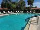 Refreshing community pool with plenty of lounge chairs and lush landscaping at 3500 El Conquistador Pkwy # 347, Bradenton, FL 34210