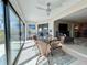 A bright sunroom offers a glass dining table, and sliding glass doors to a lovely backyard space at 3500 El Conquistador Pkwy # 347, Bradenton, FL 34210
