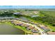 Stunning aerial view showcasing the home's location with a lake view and lush community at 3504 Big Sky Way, Bradenton, FL 34211
