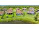 Aerial view of a home with a large backyard, screened pool, and lush green surroundings in a Gathering neighborhood at 3504 Big Sky Way, Bradenton, FL 34211