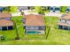 Aerial view of a house with a screened-in pool and fenced backyard in a lush residential neighborhood at 3504 Big Sky Way, Bradenton, FL 34211