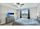 Comfortable bedroom with ceiling fan, dresser, and serene lake view at 3504 Big Sky Way, Bradenton, FL 34211