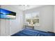 Bright bedroom featuring a mounted TV, natural light, and a closet for ample storage at 3504 Big Sky Way, Bradenton, FL 34211