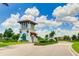 Community entrance featuring a guard house, landscaped grounds, and decorative lighting at 3504 Big Sky Way, Bradenton, FL 34211