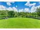 Large dog park with green grass, benches, and a secure fence, perfect for pets to run and play at 3504 Big Sky Way, Bradenton, FL 34211