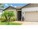 Inviting front entrance with stone accents, manicured landscaping, and charming details at 3504 Big Sky Way, Bradenton, FL 34211
