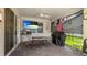 Covered outdoor patio includes TV, grill, table with seating, and lovely yard view at 3504 Big Sky Way, Bradenton, FL 34211