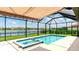 Screened-in pool and spa offer beautiful lake views and a relaxing outdoor experience at 3504 Big Sky Way, Bradenton, FL 34211