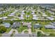 Drone shot showcases home with a circular driveway and swimming pool in a quiet neighborhood at 3621 S Lockwood Ridge Rd, Sarasota, FL 34239