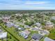 Aerial view of property featuring a swimming pool, lush lawn, mature trees, and close proximity to city amenities at 3621 S Lockwood Ridge Rd, Sarasota, FL 34239