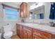 Bright bathroom featuring updated vanity, mirror, and window with natural light at 3621 S Lockwood Ridge Rd, Sarasota, FL 34239