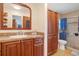 Bathroom featuring a vanity with storage and a tiled glass shower at 3621 S Lockwood Ridge Rd, Sarasota, FL 34239