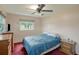 Bedroom featuring a ceiling fan, two windows and two wooden chests of drawers at 3621 S Lockwood Ridge Rd, Sarasota, FL 34239
