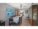 Bright dining room with luxury vinyl floors, a ceiling fan, and wooden furniture at 3621 S Lockwood Ridge Rd, Sarasota, FL 34239