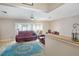 Open living room featuring a fan, neutral paint, and a view to the screened in porch at 3621 S Lockwood Ridge Rd, Sarasota, FL 34239