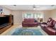 Comfortable seating in the inviting living room area, with a view to the screened in porch at 3621 S Lockwood Ridge Rd, Sarasota, FL 34239
