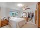 Bright bedroom featuring a queen bed, ceiling fan, closet and an ensuite bathroom at 3621 S Lockwood Ridge Rd, Sarasota, FL 34239