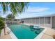 Enjoy this backyard swimming pool with patio area, tropical plants, and adjacent outdoor seating at 3621 S Lockwood Ridge Rd, Sarasota, FL 34239