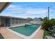 Backyard swimming pool view featuring patio area, tropical landscaping, and the home's screened-in porch at 3621 S Lockwood Ridge Rd, Sarasota, FL 34239