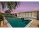 Relaxing backyard pool view featuring mature landscaping and an enclosed screened patio at 3621 S Lockwood Ridge Rd, Sarasota, FL 34239