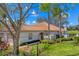 Charming single-story home featuring a tile roof, mature landscaping, and a welcoming entrance gate at 3881 Chatsworth Greene Ct # 20, Sarasota, FL 34235