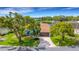 Beautiful waterfront property featuring lush landscaping, mature trees, and screened-in lanai with stunning views at 4120 51St W Dr, Bradenton, FL 34210