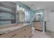 Dual vanities with granite countertops, modern lighting, and a glass-enclosed walk-in shower in this spacious bathroom at 4120 51St W Dr, Bradenton, FL 34210