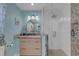 Updated bathroom featuring granite countertops, round mirror, and walk-in shower with white subway tile at 4120 51St W Dr, Bradenton, FL 34210