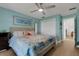 Coastal-themed bedroom with ceiling fan, hardwood floors, a full-length mirror, and a closet at 4120 51St W Dr, Bradenton, FL 34210