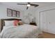 Bright bedroom with hardwood floors, ceiling fan, closet, and palm tree wall art for a coastal touch at 4120 51St W Dr, Bradenton, FL 34210