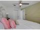 Relaxing bedroom features a coastal theme, modern fan, and ensuite bathroom entrance at 4120 51St W Dr, Bradenton, FL 34210