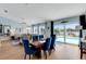 Open-concept dining area with modern furnishings and large windows overlooking the pool and backyard at 4120 51St W Dr, Bradenton, FL 34210