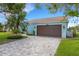 Well-maintained home includes a paver driveway, lawn, blue exterior, and a two-car garage at 4120 51St W Dr, Bradenton, FL 34210