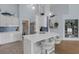 Bright kitchen with white cabinets, a breakfast bar, and views into the dining and living area at 4120 51St W Dr, Bradenton, FL 34210