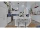 Modern kitchen features white cabinets, stainless appliances, a breakfast bar, and pendant lighting at 4120 51St W Dr, Bradenton, FL 34210