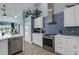 Well-equipped kitchen featuring stainless appliances, tiled floors, and a view of the outdoor pool area at 4120 51St W Dr, Bradenton, FL 34210
